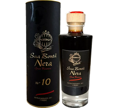A bottle of Sua Bontà Nera Gran Riserva, an elegant balsamic condiment, looks refined next to its packaging.
